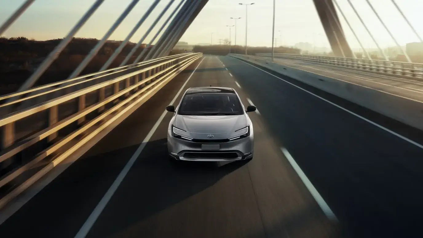 Current-generation Toyota Prius photographed straight on from the front showing the low wide stance