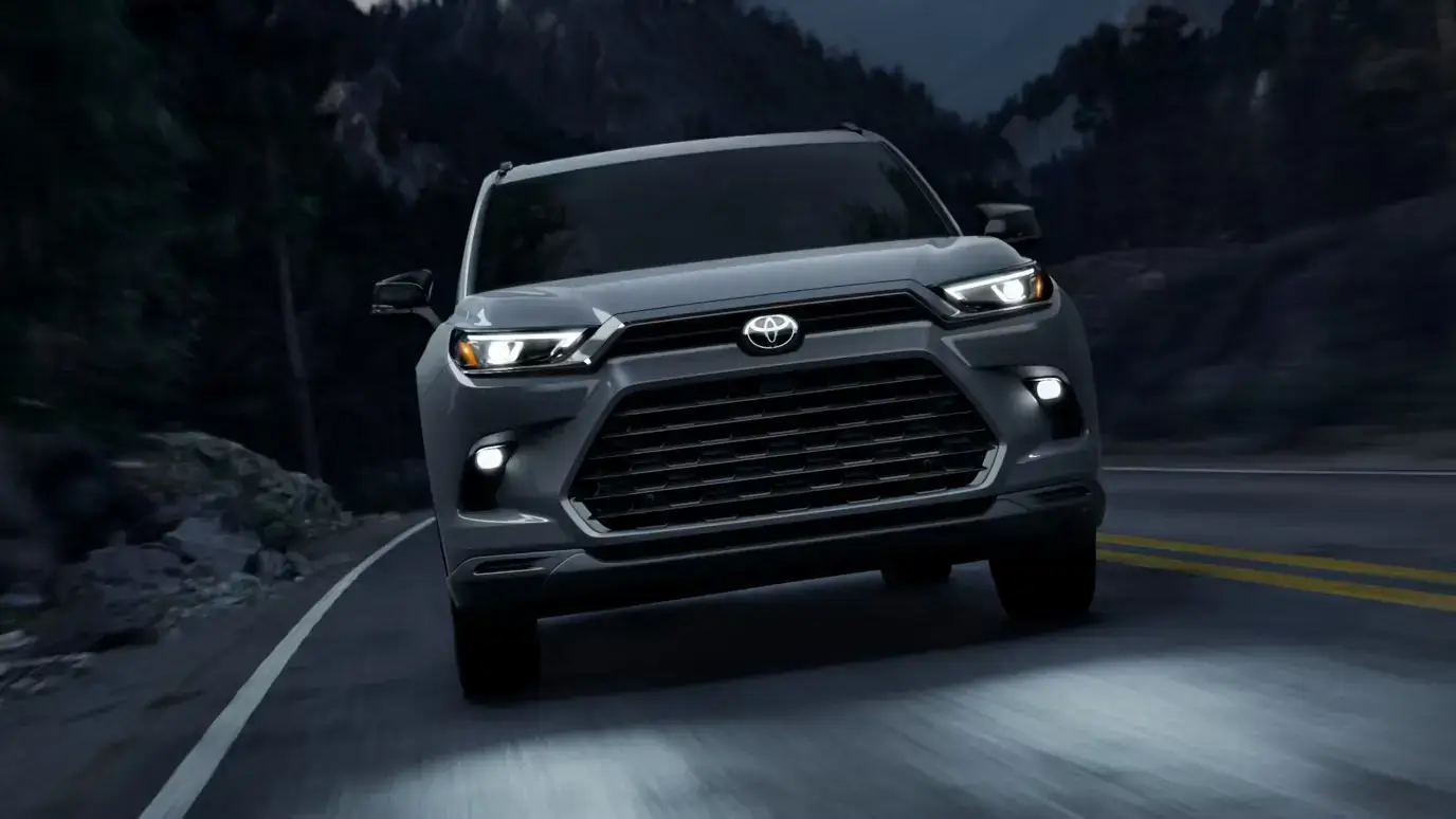 Toyota Grand Highlander Hybrid Nightshade in Cement shown from the front with blacked-out grille and badging