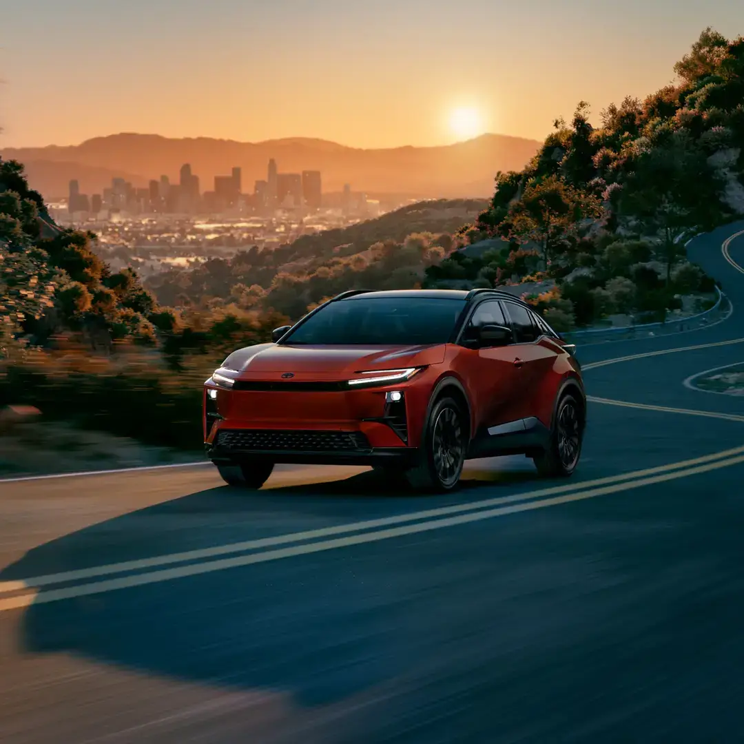 Front three-quarter view of the Toyota C-HR electric SUV showing its wide stance and coupe profile