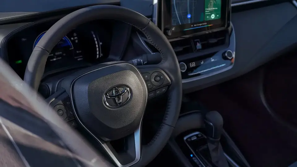 Toyota Corolla dashboard and front seats viewed from the driver's window