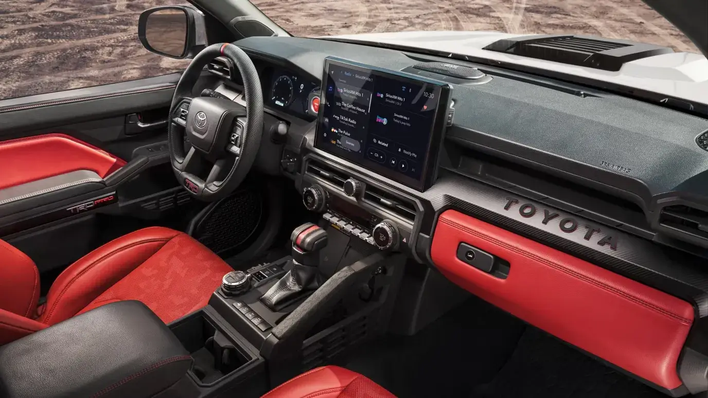 Toyota Tacoma i-FORCE MAX TRD interior with red accents on the dashboard and seats