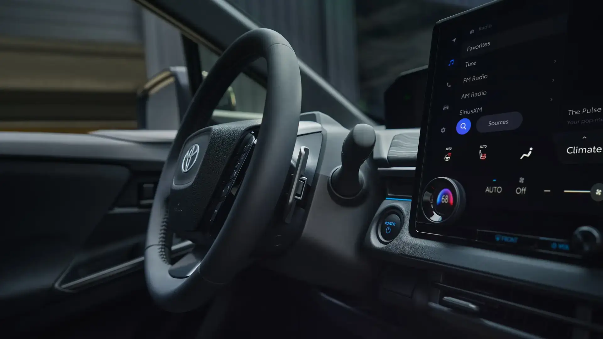Toyota C-HR interior showing the 14-inch touchscreen, climate controls and heated steering wheel