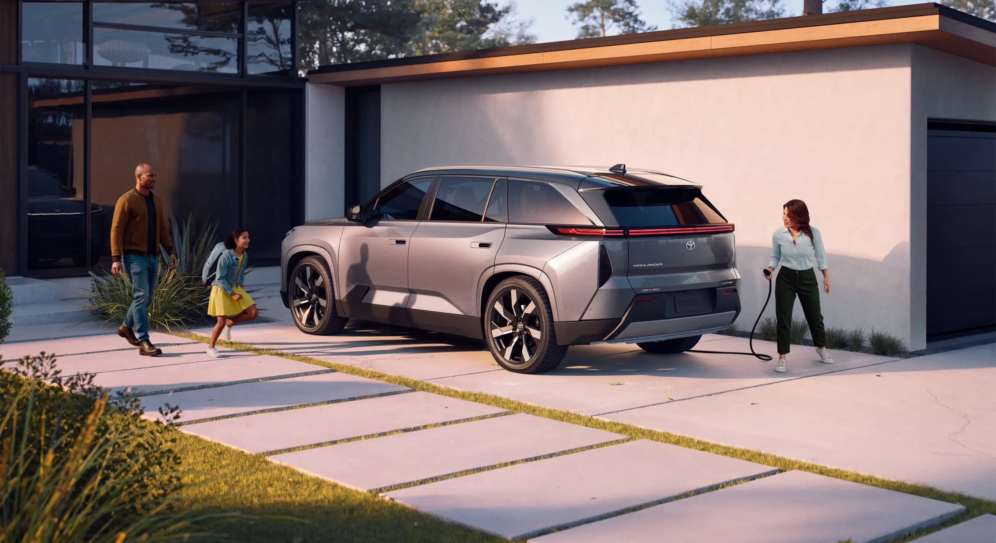 2027 Toyota Highlander shown from the rear three-quarter angle with its full-width LED light bar
