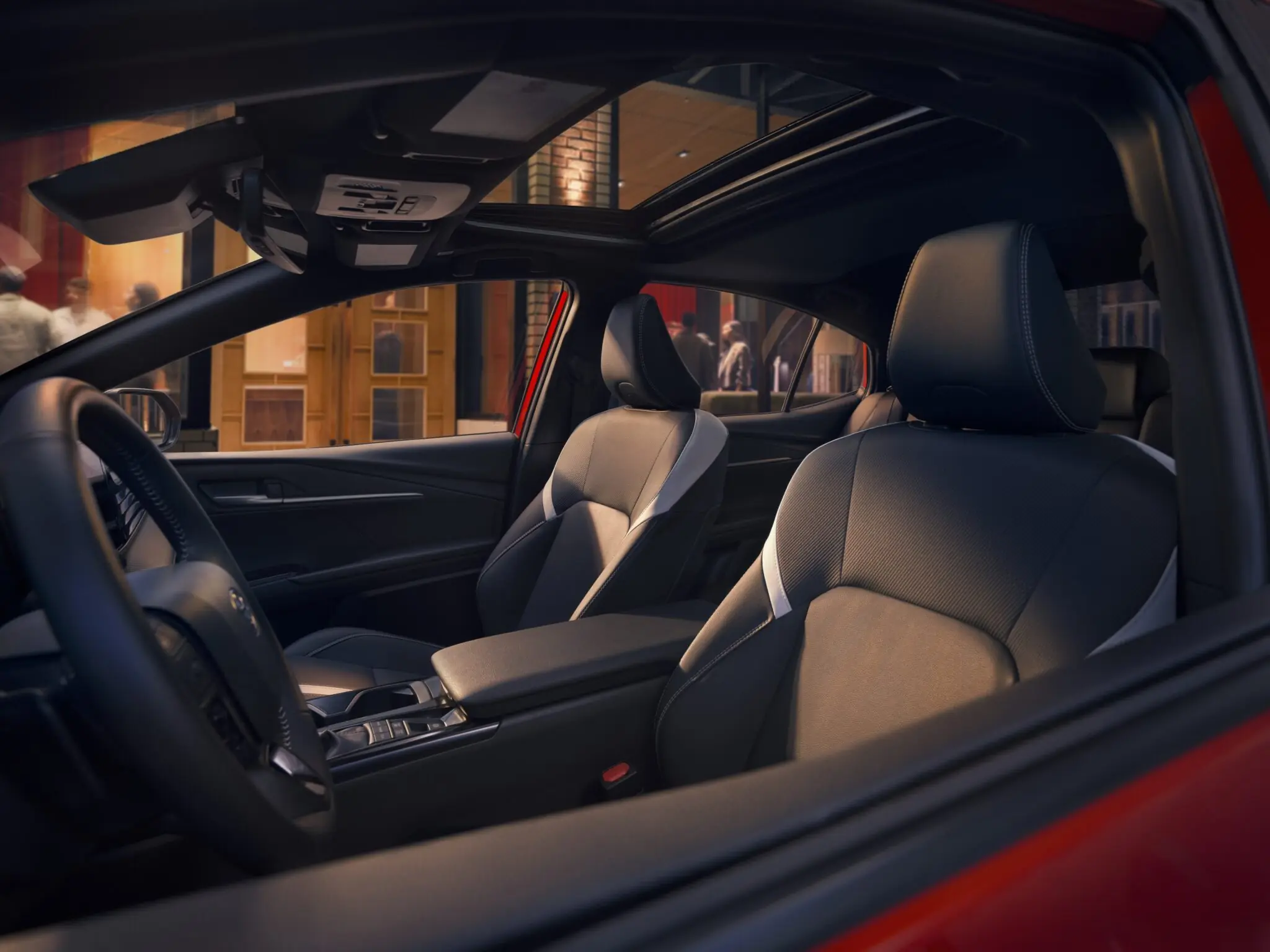 Toyota Camry front seats and steering wheel, seen through the open door
