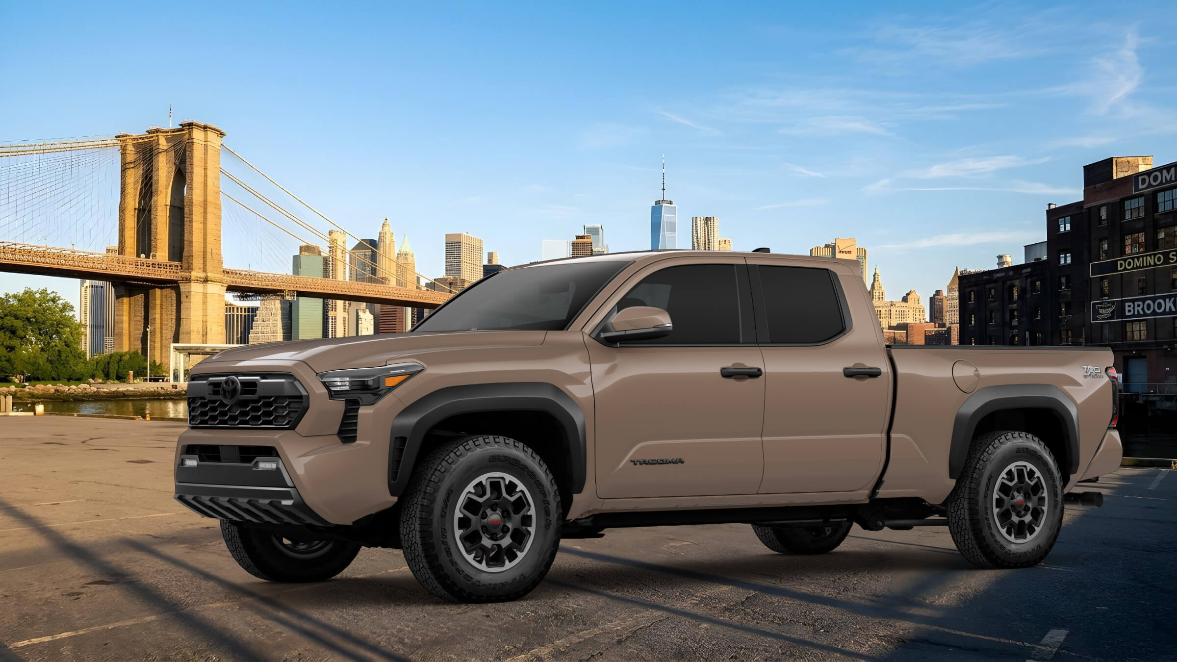 Toyota Tacoma pickup truck in front of the Brooklyn Bridge and the Manhattan skyline