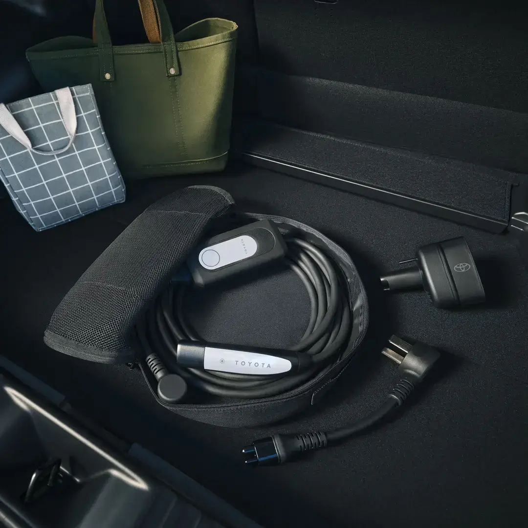 Toyota C-HR charging from a standard household outlet using the included dual-voltage charging cable
