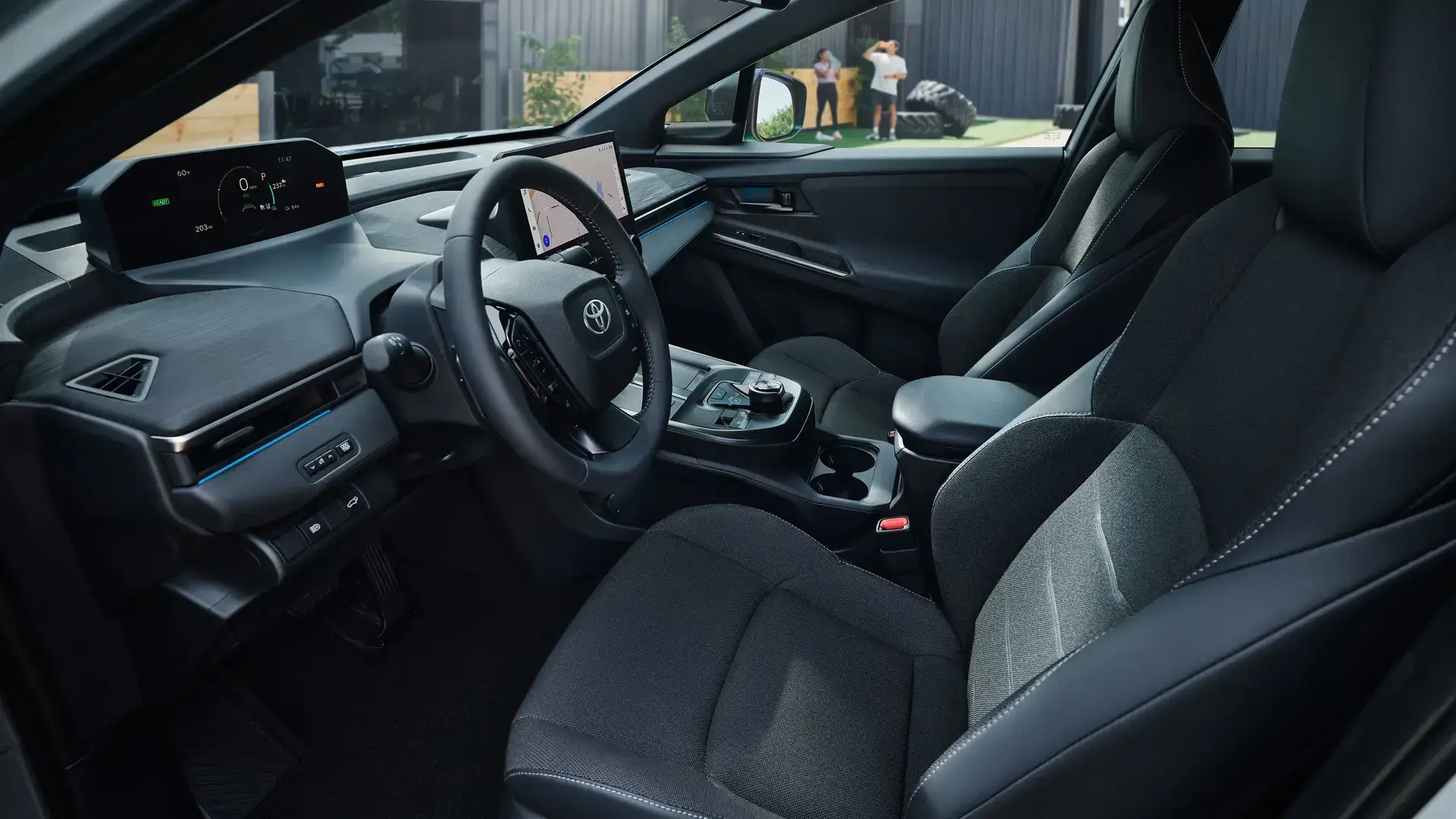 Toyota C-HR driver seat and cabin showing SofTex trimmed seating and digital instrument display