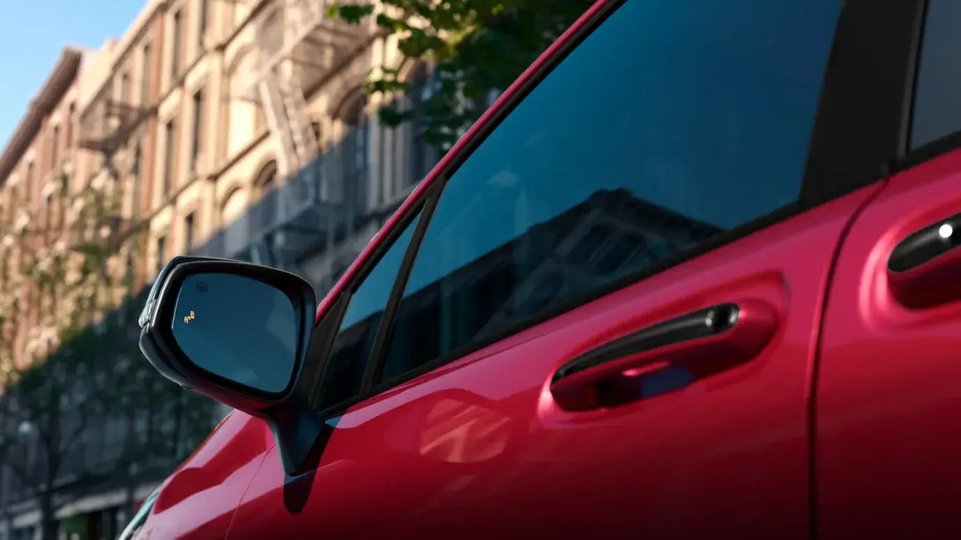 Exterior detail of the Toyota Sienna driver door handle and side mirror