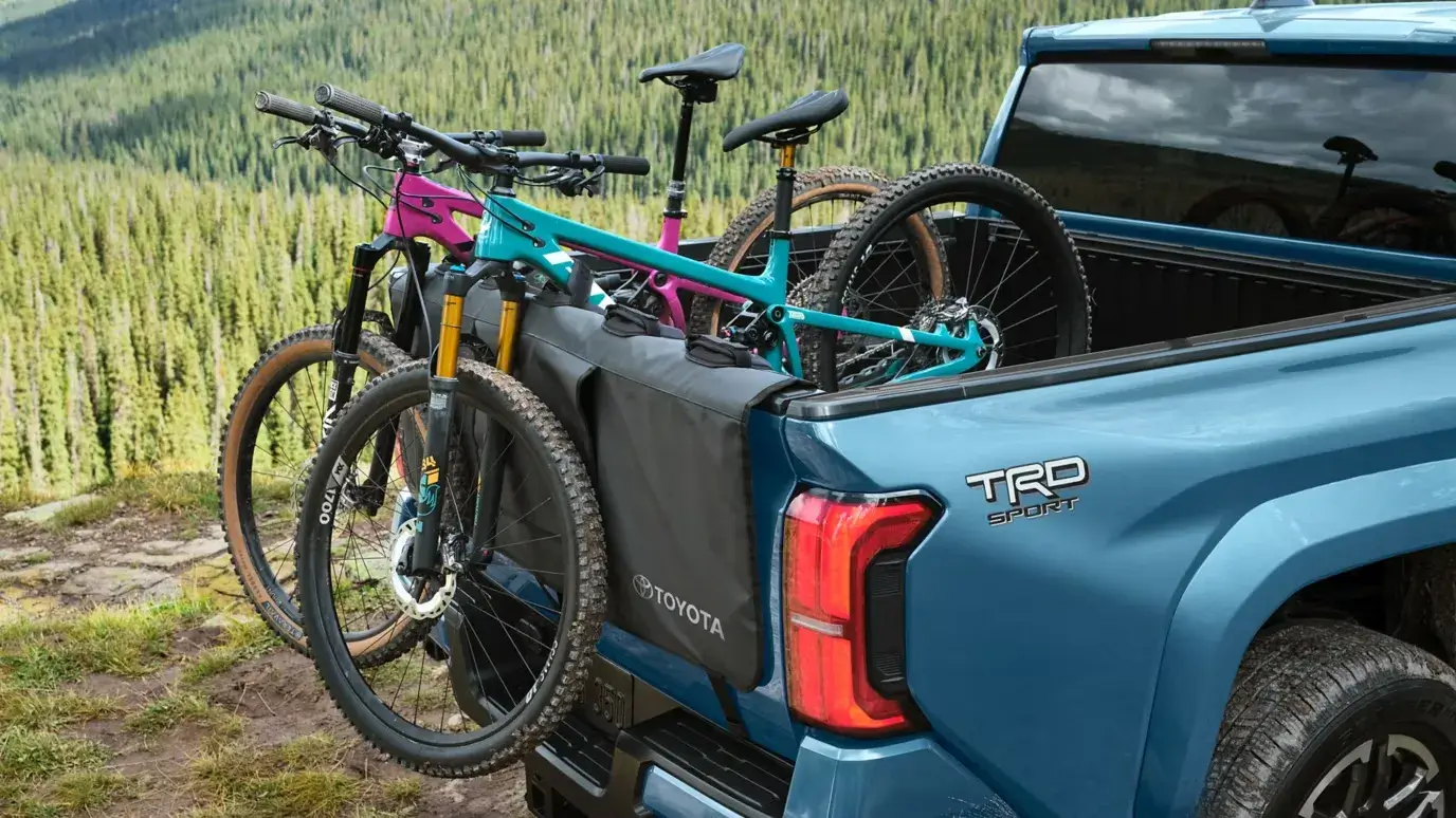 Bicycles secured over the tailgate of a Toyota Tacoma