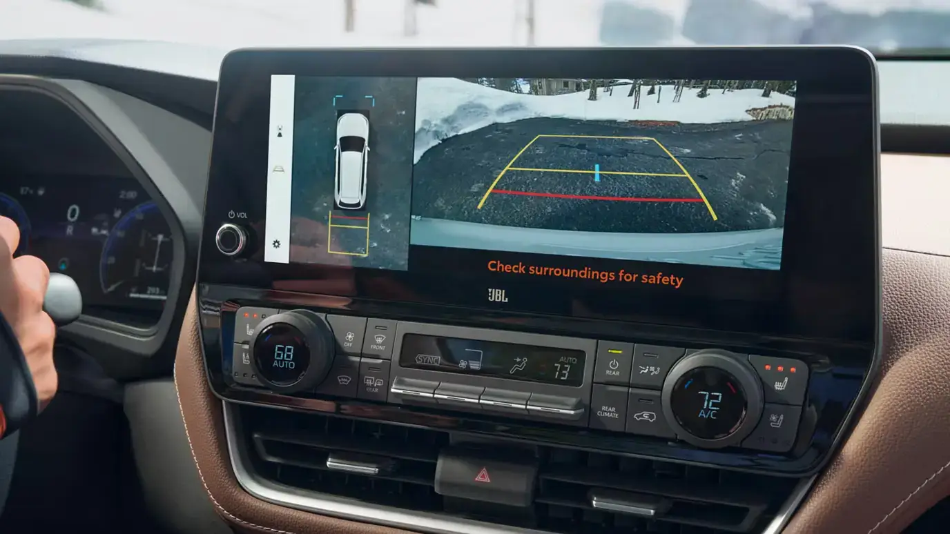Toyota Grand Highlander climate controls and center screen showing the panoramic view monitor with rear camera