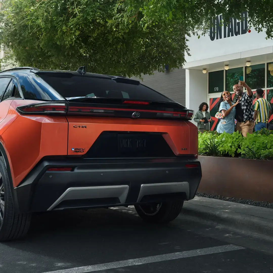 Rear view of the Toyota C-HR showing the full-width light bar and sculpted tailgate