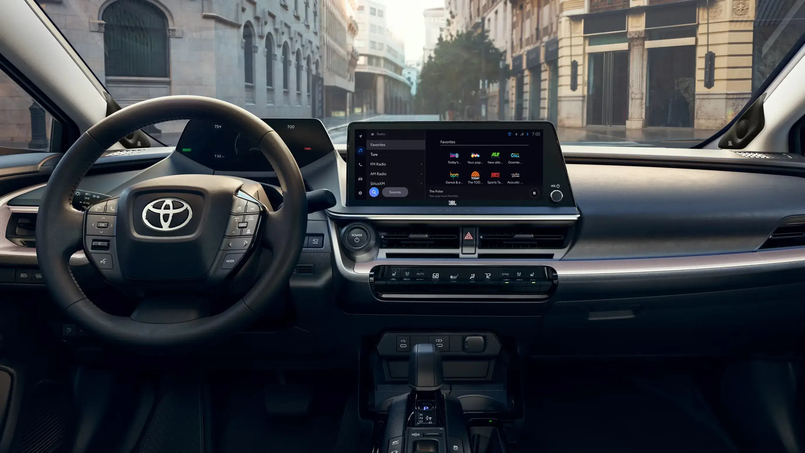 Toyota Prius dashboard panel showing the multimedia screen and steering wheel from the driver's seat