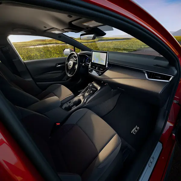 Toyota Corolla interior viewed through the open front passenger door