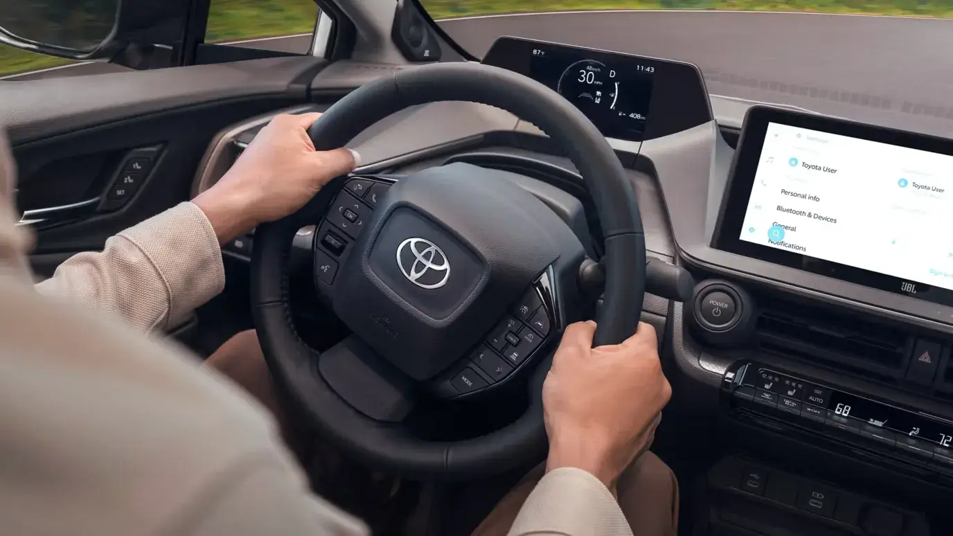 2027 Toyota Prius interior from the driver's side showing the low dashboard and instrument binnacle