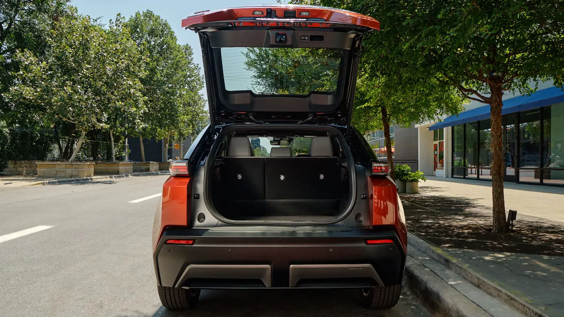 Toyota C-HR with the power liftgate open showing the rear cargo area and 1500-watt outlet