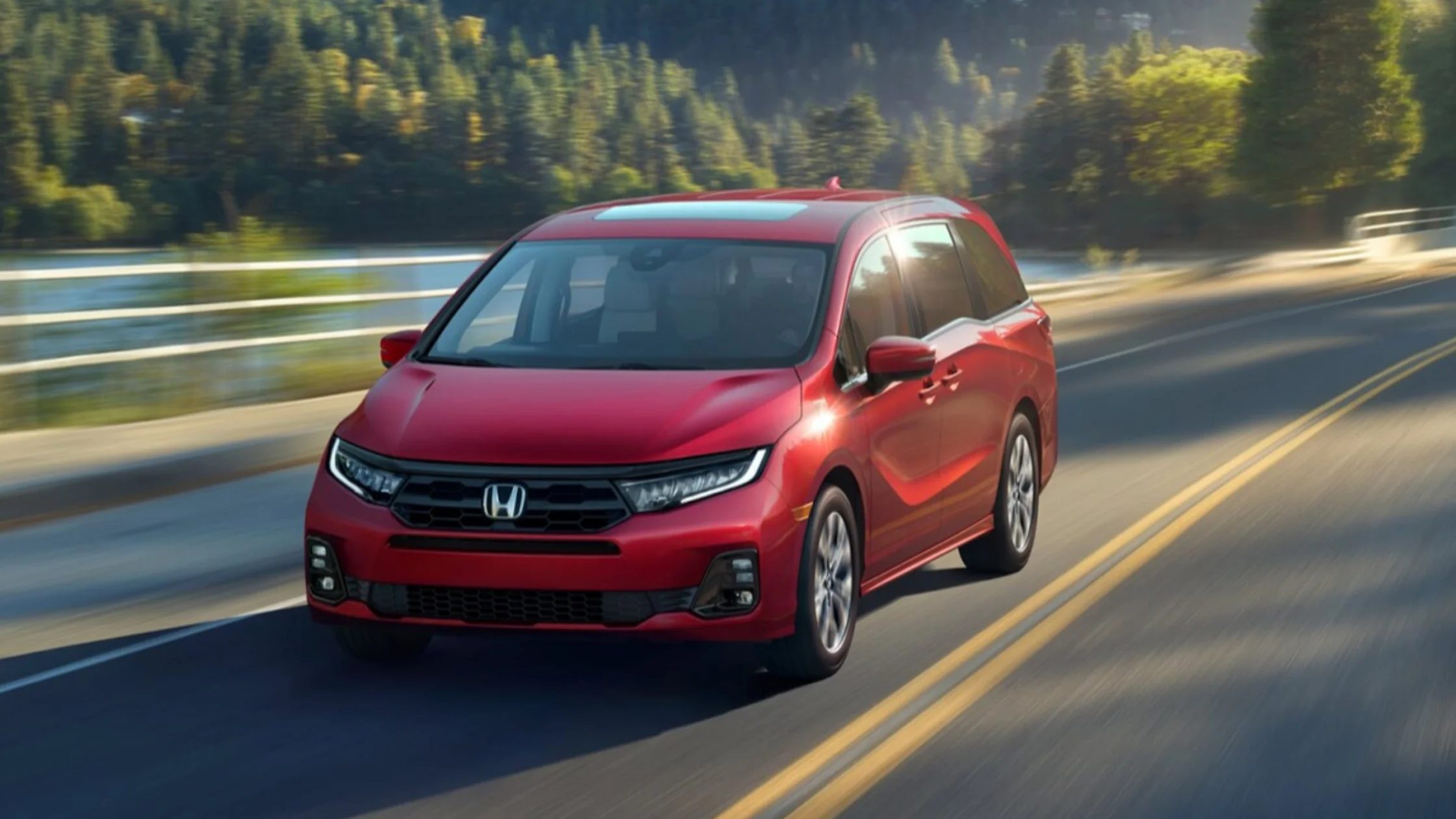 2026 Honda Odyssey minivan with sleek red exterior and road-ready styling