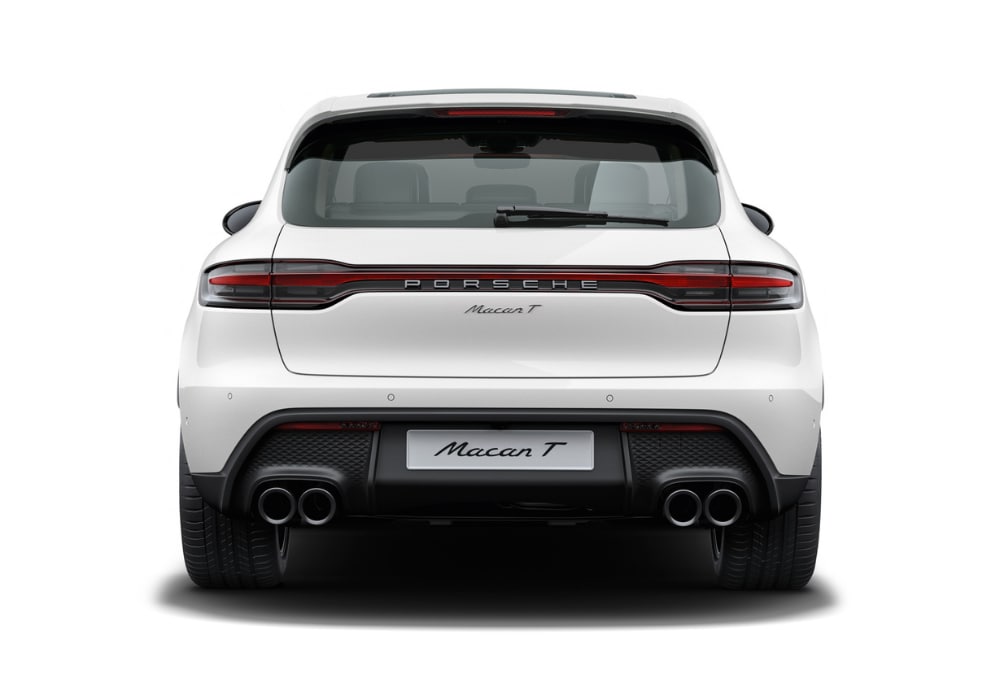 Rear view of a 2025 Porsche Macan in front of a white background. The Macan logo is visible on the back of the car