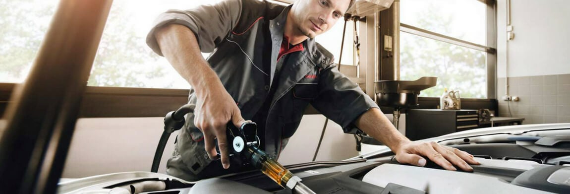 Porsche technician performing an oil change