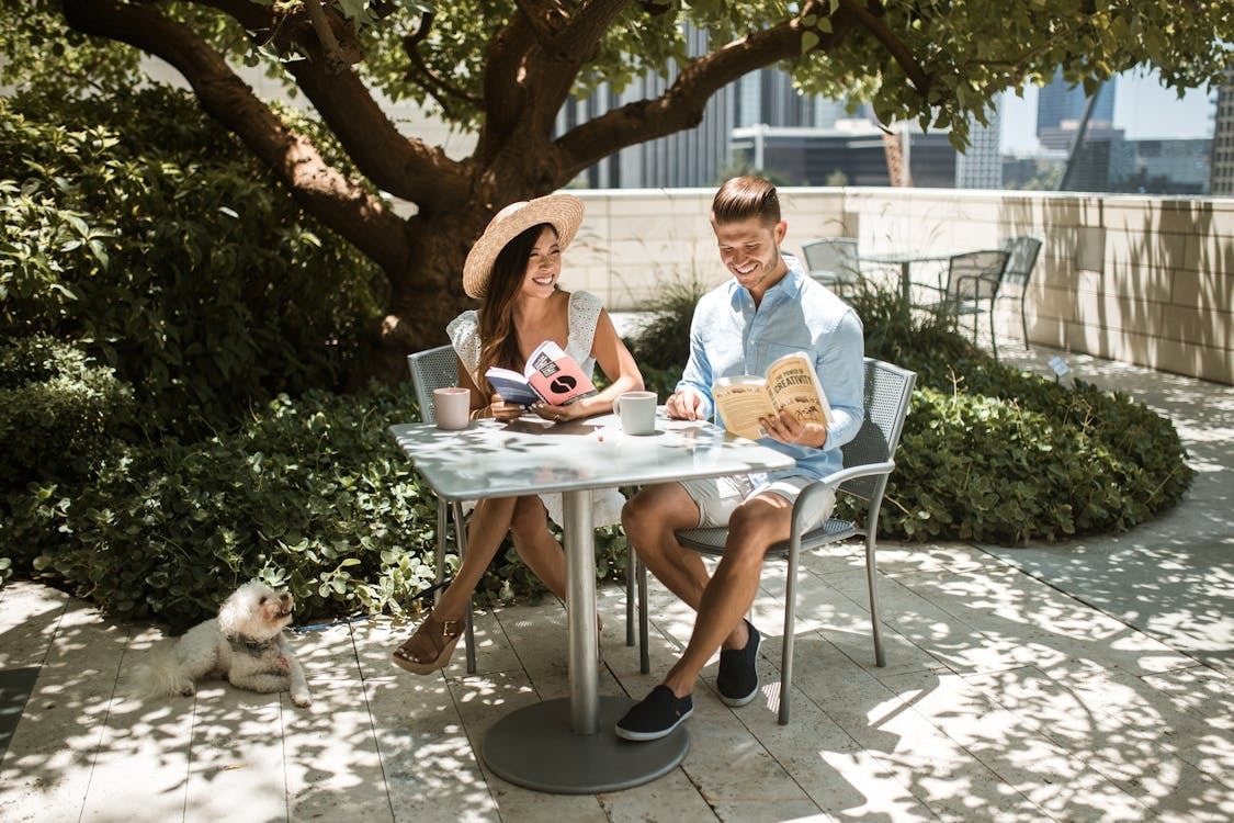 Couple sitting at a dog friendly restaurant with their dog