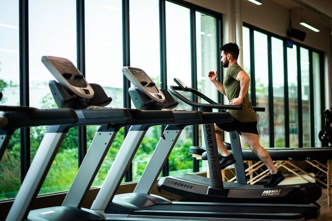 Man running on a treadmill at a gym
