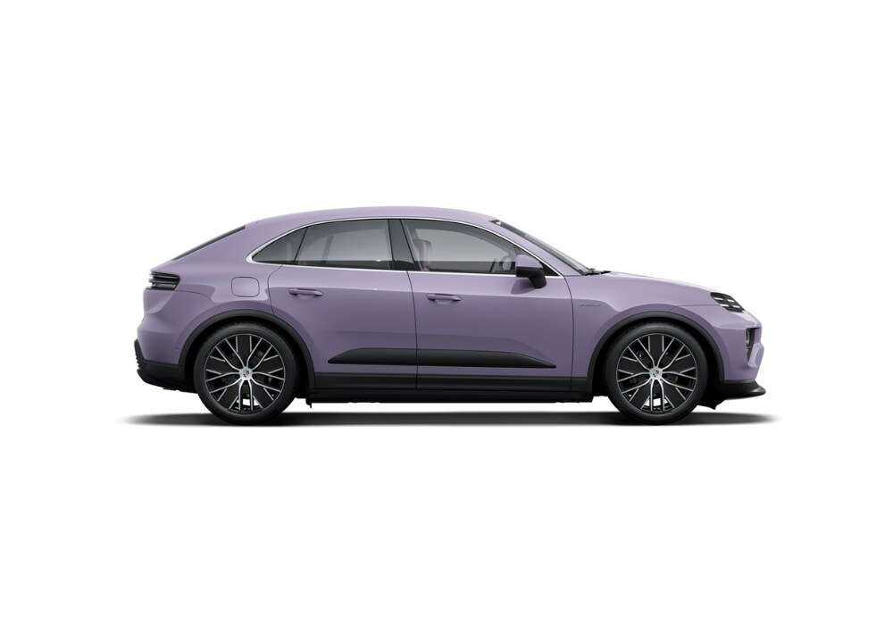 Passenger's side view of a new Porsche Macan EV in front of a white background