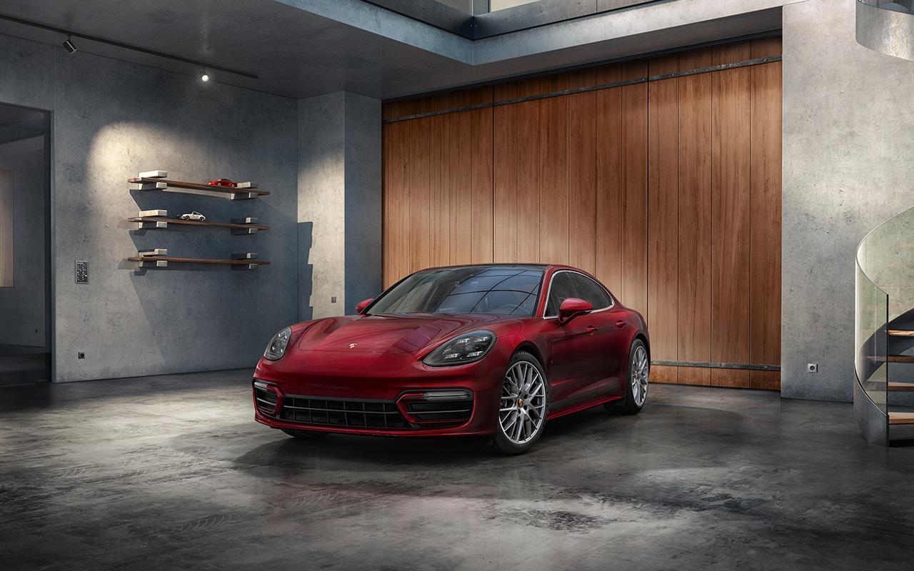 red Porsche Panamera parked in a large garage