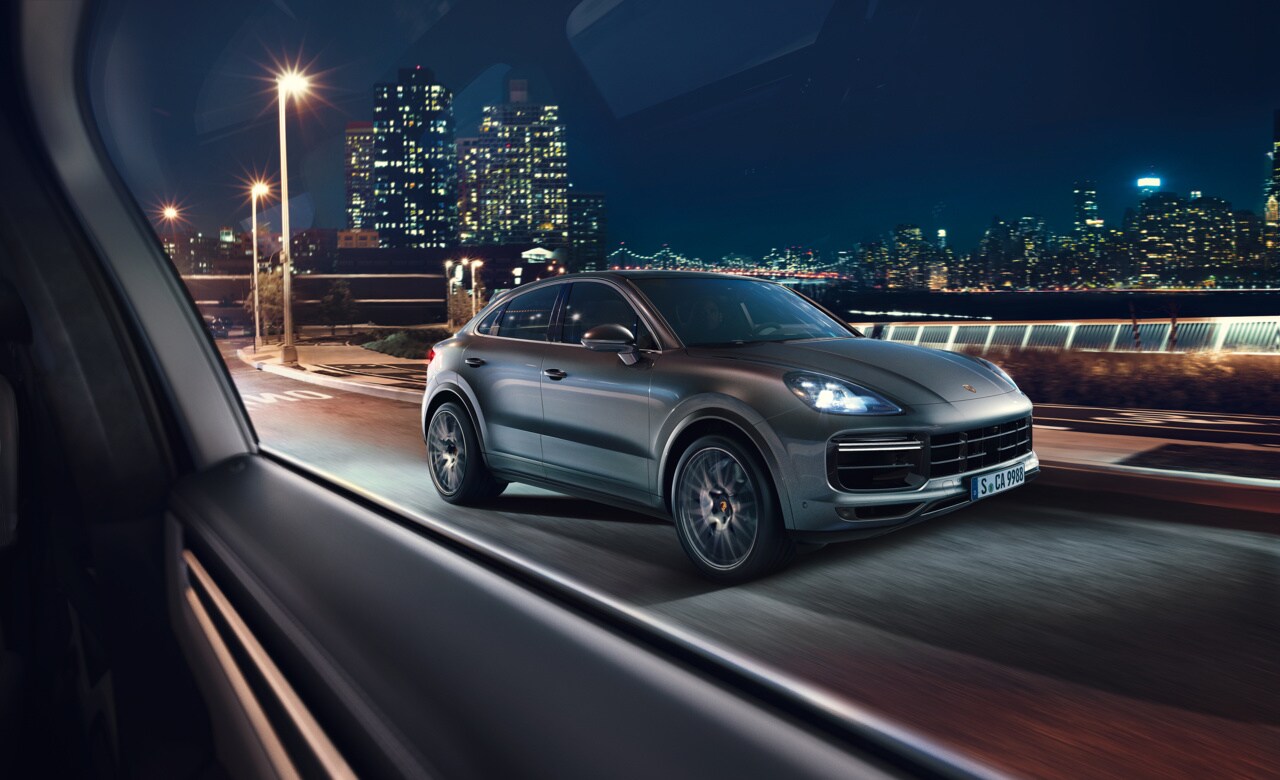 Porsche Cayenne Coupe on highway at night