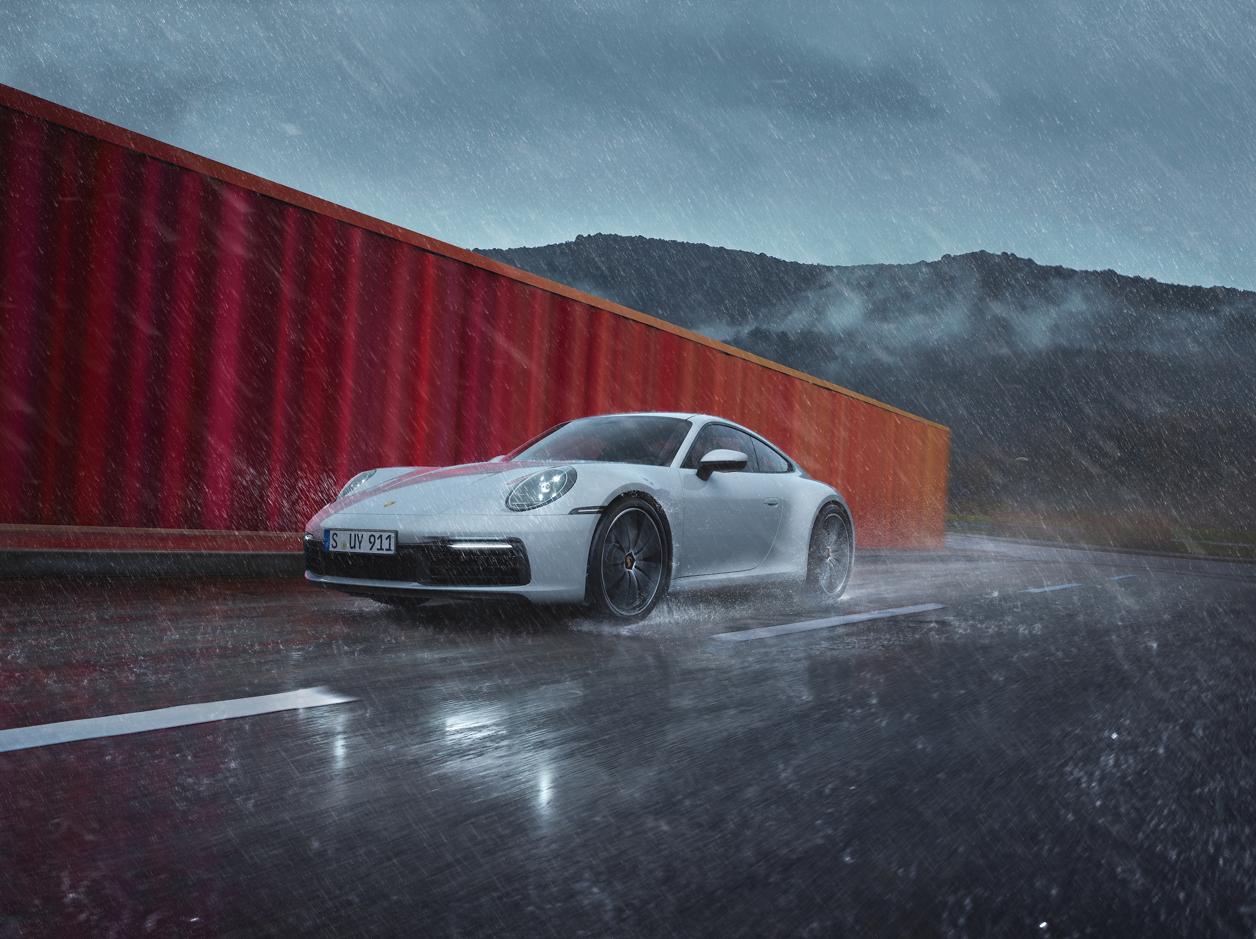 Porsche 911 Carrera driving in rain