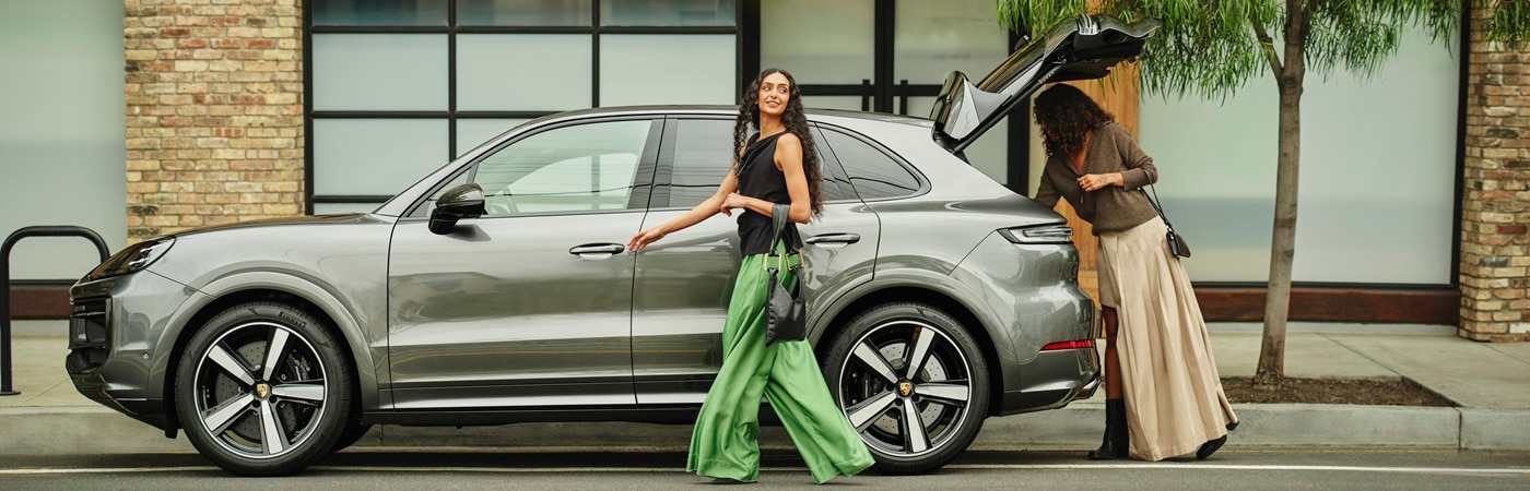 A person loading items into the trunk of a Cayenne S