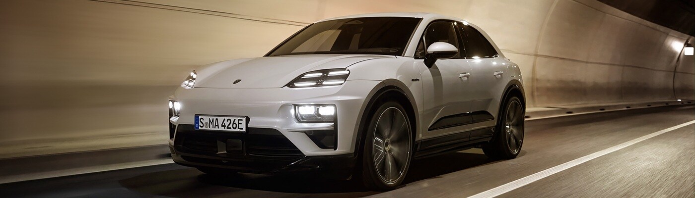 White Porsche Macan Electric driving in a tunnel in a city