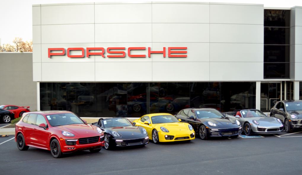 Exterior view of Porsche Towson with row of Porsche vehicles parked in front