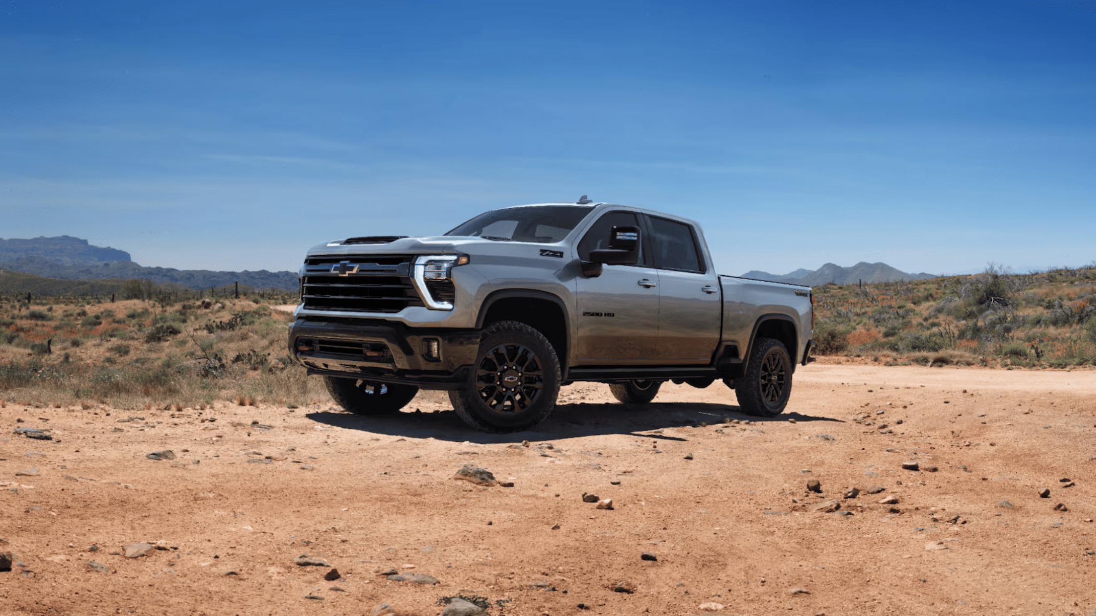 Fayetteville tradesmen load gear into a 2025 Chevrolet Silverado HD, showcasing its rugged bed and powerful work-ready design.
