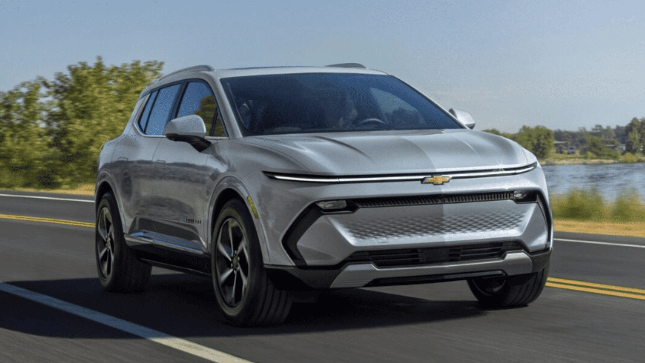2025 Chevrolet Equinox EV on highway near Fort Bragg during electric SUV comparison