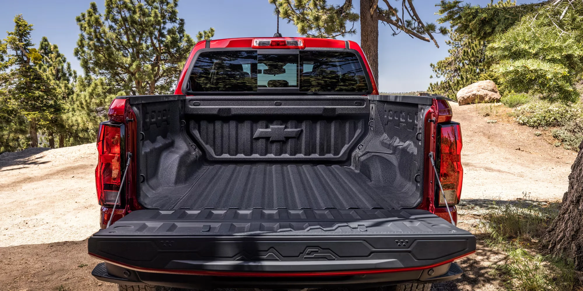 2026 Chevy Colorado bed and tailgate open, showing bed tie-downs and cargo bed lighting
