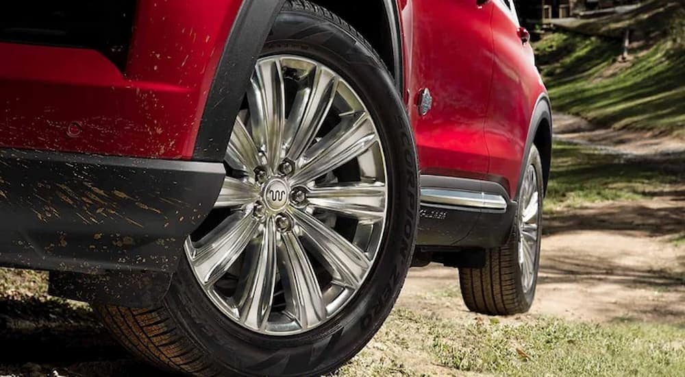 A close up of the rim on a red 2023 Explorer King Ranch.