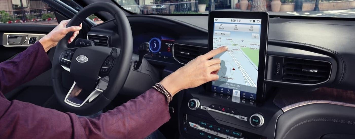 A person using the infotainment screen in a 2021 Ford Explorer.