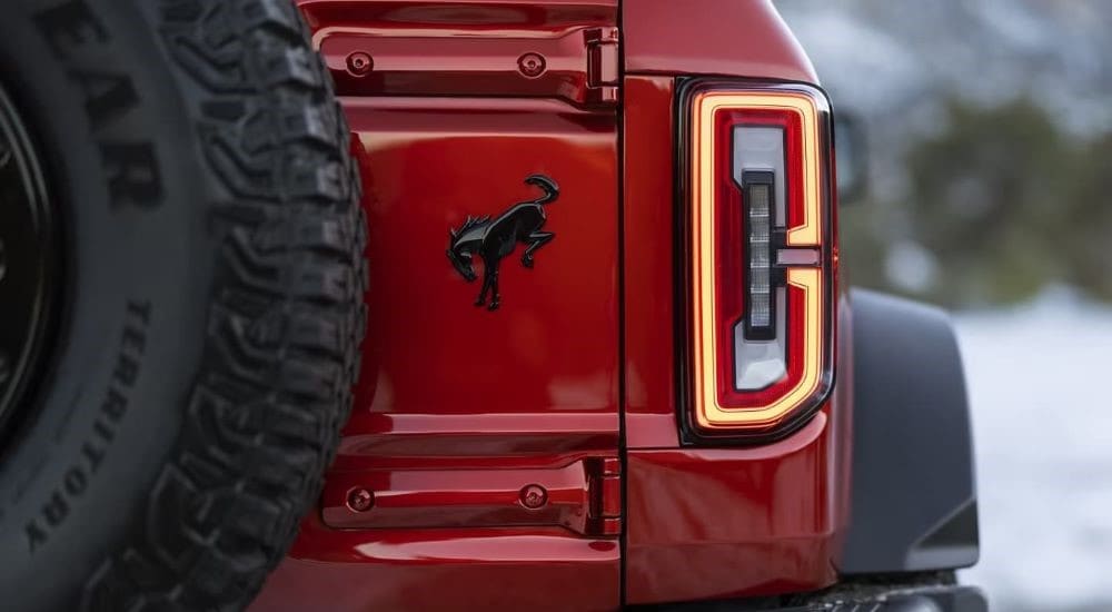 A close up of the passenger side taillight on a red 2024 Ford Bronco Wildtrak at a Ford dealer near me.