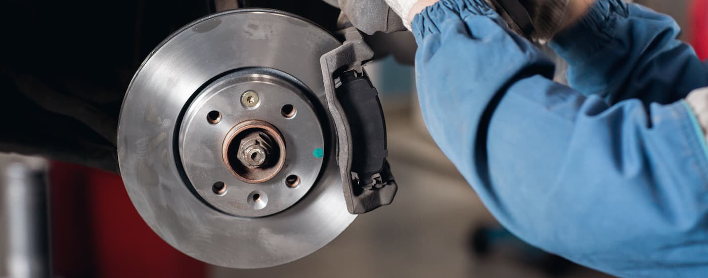 A mechanic is shown replacing brakes at a Ford service center near Brooklyn.