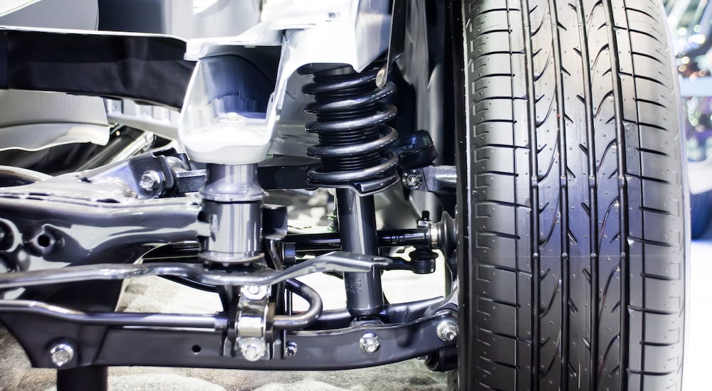 The front suspension of a car is shown in a cutaway view.