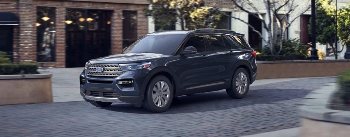 A grey 2022 Ford Explorer for sale driving on a city street.