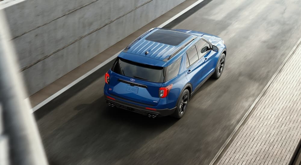 Aerial view of a blue 2023 Ford Explorer ST driving on a highway ramp.