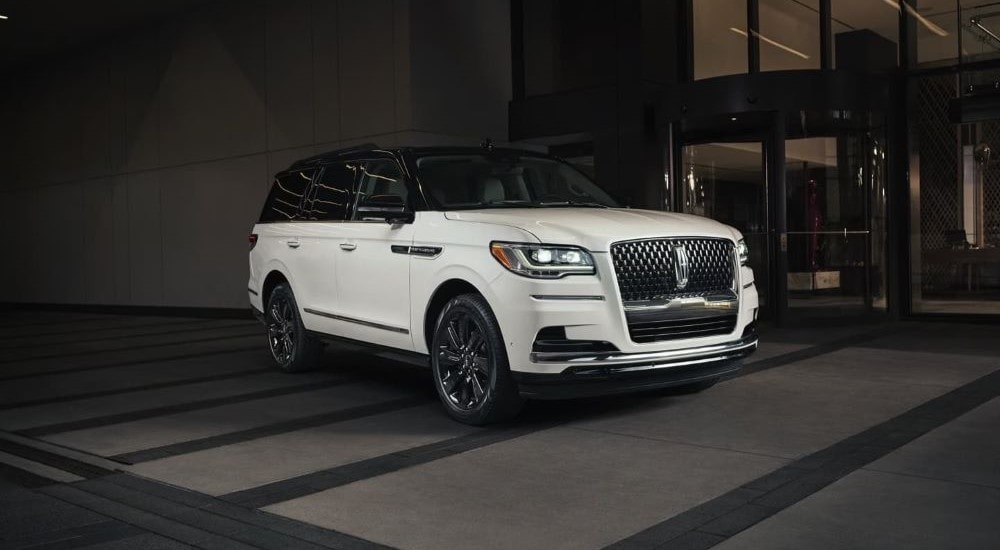 A white 2023 Lincoln Navigator parked in front of a city building after leaving a Brooklyn Lincoln dealer.