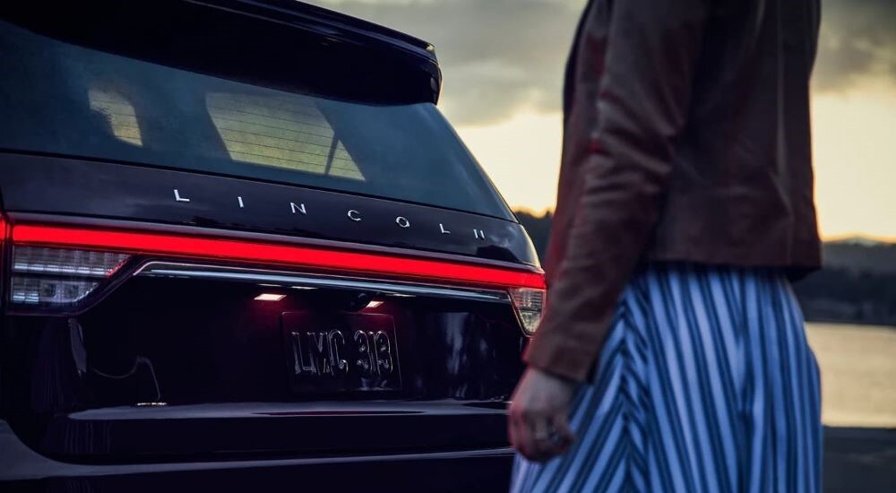 Close-up of the rear of a black 2023 Lincoln Aviator at a Lincoln dealer.