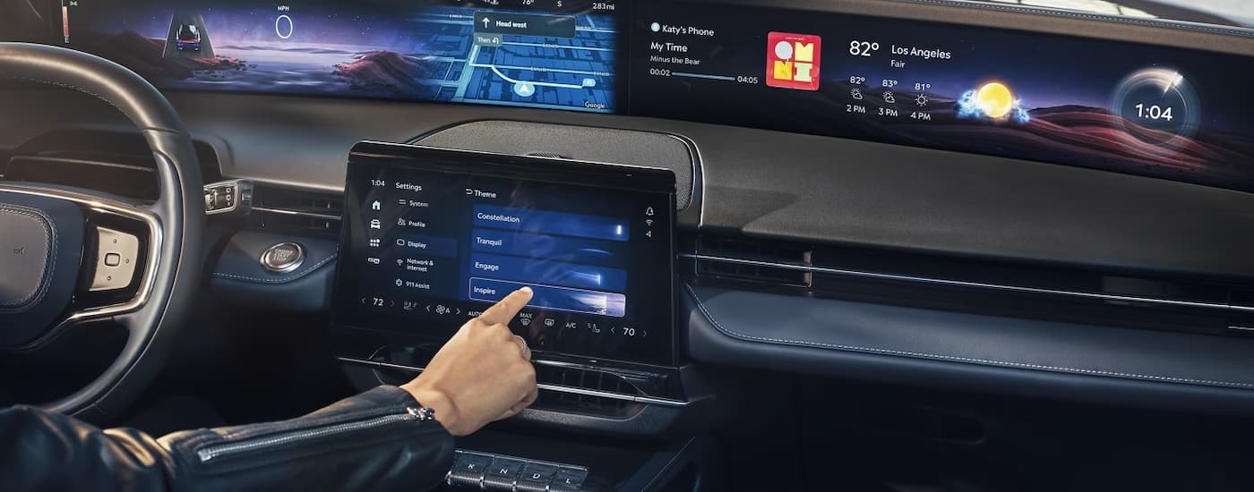A person is shown using the infotainment screen in a 2024 Lincoln Nautilus.