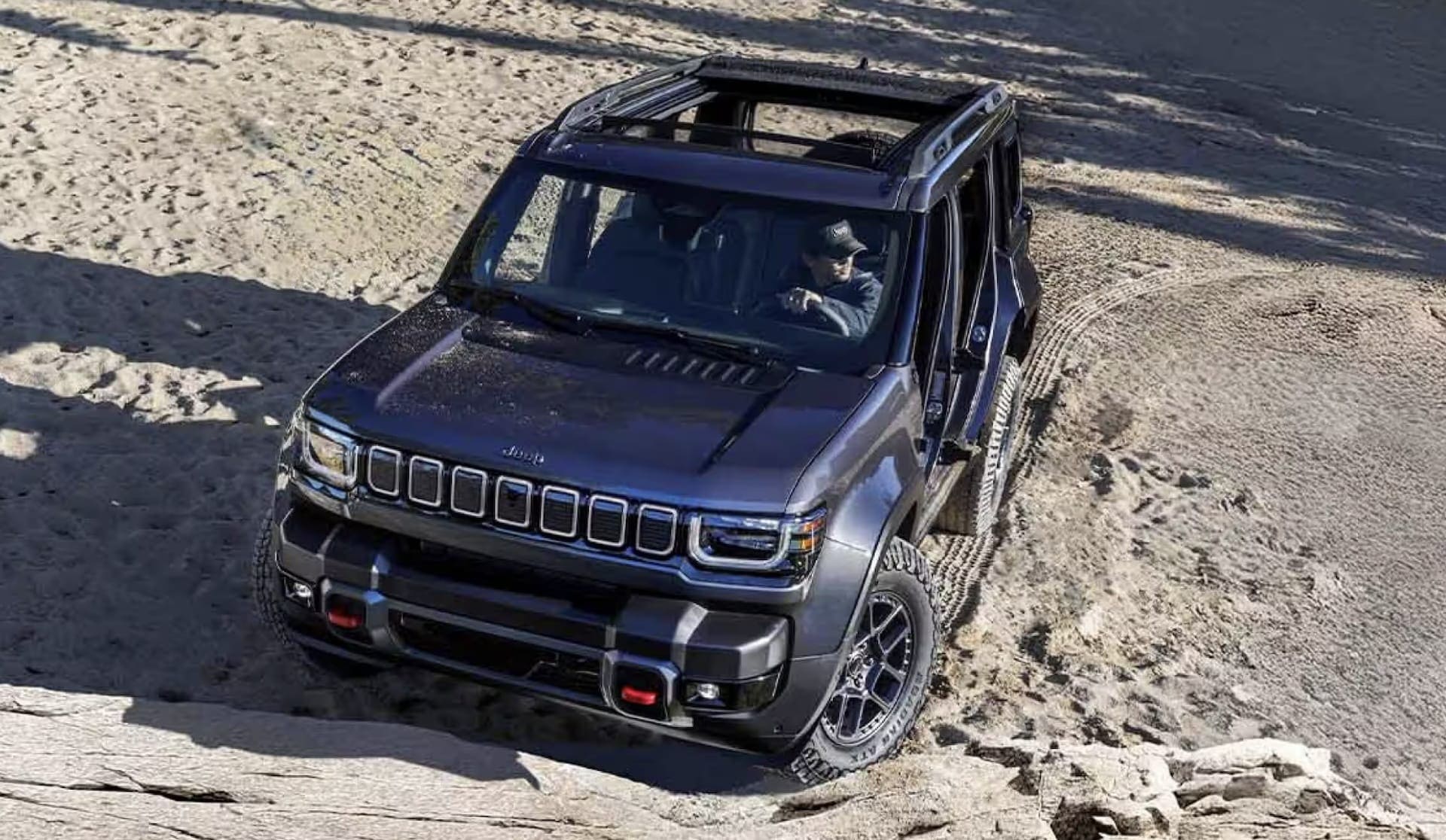 Rear three-quarter view of a 2026 Jeep Recon with the swing gate spare tire