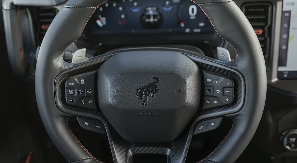 A close up of the steering wheel and digital dashboard in a 2024 Ford Bronco.