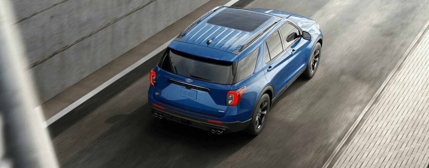 Aerial view of a blue 2023 Ford Explorer ST driving on a highway ramp.