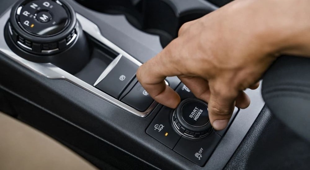 A hand turning the G.O.A.T. knob in a 2022 Ford Bronco Sport.