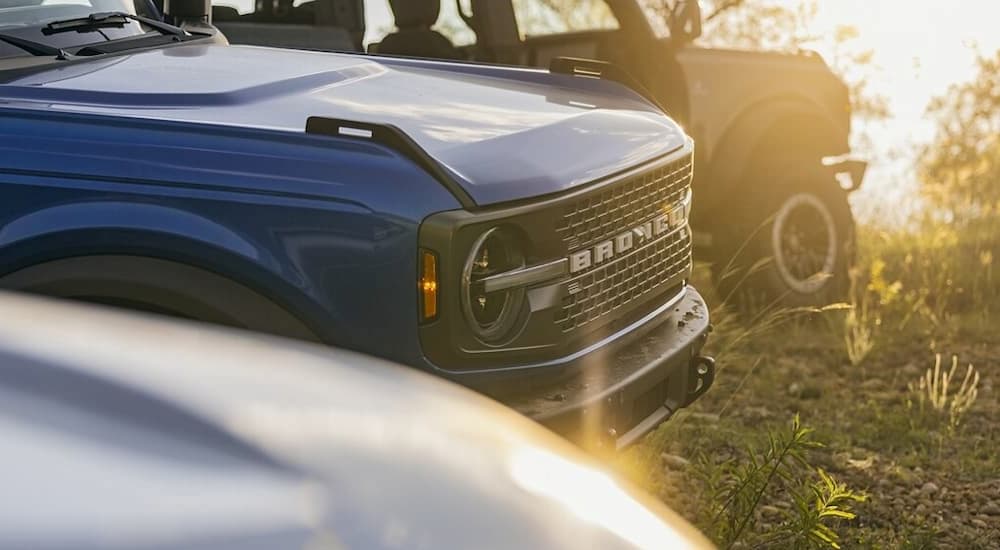 A close up of the front of a blue 2024 Ford Bronco