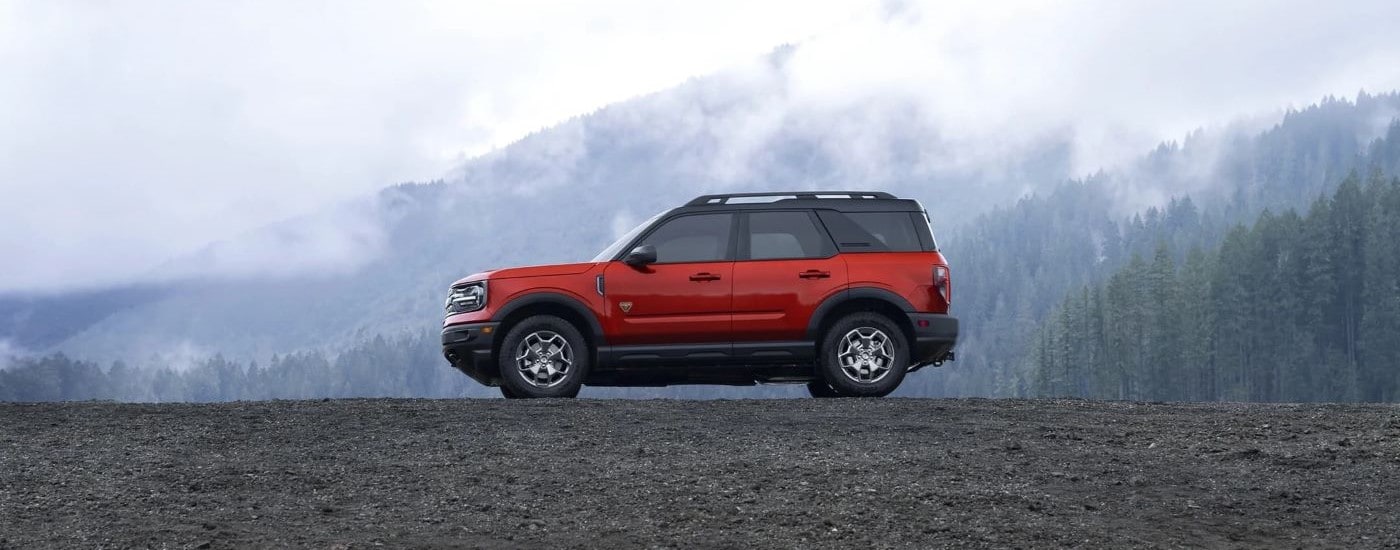 A red 2022 Ford Bronco Sport Badlands parked in the mountains on a foggy day.